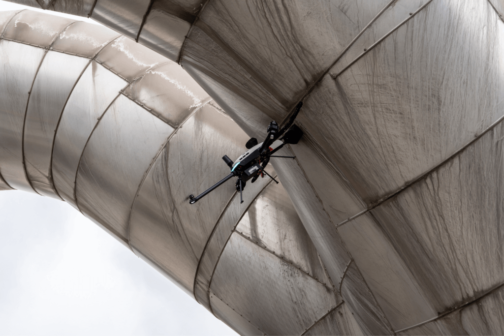 Voliro T drone on insulated pipe executing PEC inspection